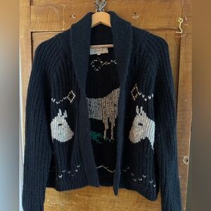 THE GREAT. Navy Shawl Cardigan with Cream Alpaca Motifs and Green Detail